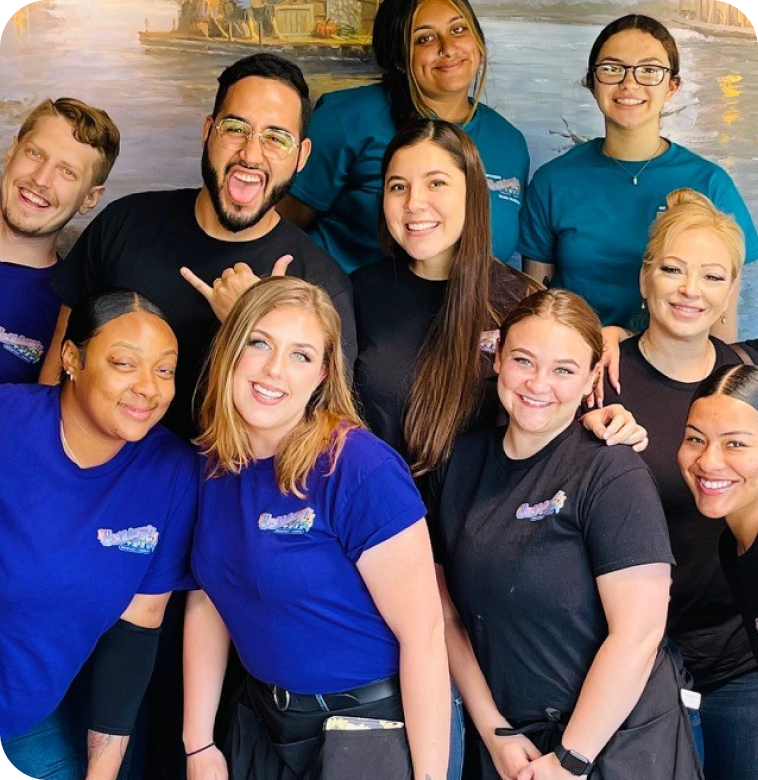 A group of people smiling while wearing Huckleberrys shirts.
