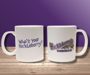 Huckleberry coffee mug with a Huckleberry logo and the slogan Who's Your Huckleberry? on the mug.